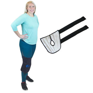 Person wearing a black knee compression wrap with a separate white fabric strap attachment