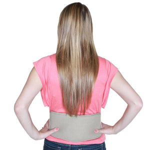 Person wearing a Polar Products beige lumbar support belt over a pink shirt