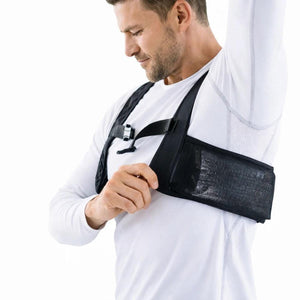 Man wearing a black Polar Quest chest harness over a white long sleeve shirt