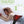 UTK Technology massage belt with three vibration levels shown on a woman lying on a bed