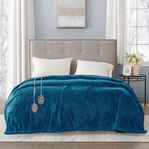 Teal plush electric heated blanket with dual controllers draped over a bed