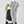White leather glove with black fabric panel and tan leather thumb reinforcement