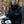 Motorcyclist wearing a Venture Heat jacket and gloves standing by a motorcycle
