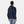 Back view of a person wearing a navy blue hooded windbreaker jacket with white trim at the hem