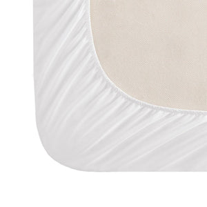 Close up of white fitted sheet corner with elastic edge