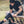Athlete adjusting a black DonJoy knee brace while sitting on a bench