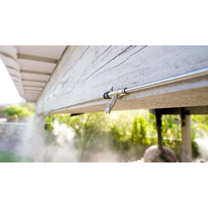 The Patio Misting System nozzle mounted on a wooden beam spraying a fine mist