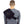 Person wearing a black shoulder support brace over a grey long sleeve shirt