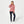 Woman wearing a red heathered quarter zip pullover with dark blue jeans and white sneakers