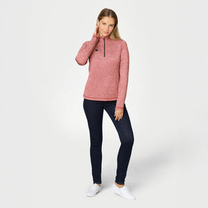 Woman wearing a red heathered quarter zip pullover with dark blue jeans and white sneakers