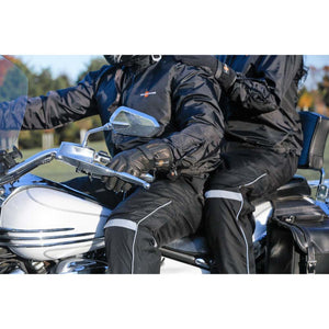 Two people wearing California Heat black heated motorcycle gear on a white motorcycle