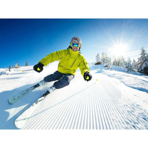 Skier wearing Dr Warm gloves and gear on a sunny snowy slope