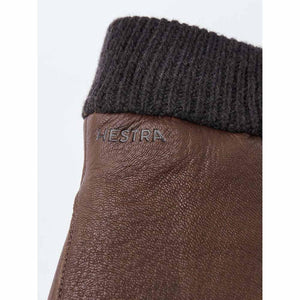 Close up of brown leather Hestra glove with dark grey ribbed wool cuff