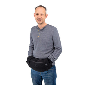 Man wearing a black waist pouch with hand warmer pockets