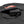 Black power bank with USB port and charging cable inside a zippered fabric pocket