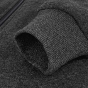 Close up of a dark grey fleece jacket sleeve with a ribbed cuff