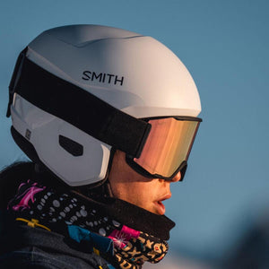 Person wearing a white Smith Optics helmet and mirrored goggles