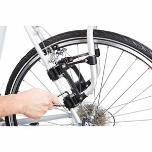 Hand using an Allen key to tighten a Thule bike rack attachment to a bicycle frame