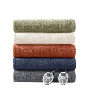 Stack of five folded Serta heated blankets in various colors with two digital controllers