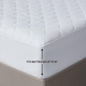 Serta white quilted mattress pad with vertical arrow graphic indicating it fits mattresses up to 18 inches deep