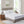White quilted mattress protector on a bed with two pillows and bedside tables