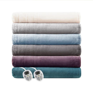 Stack of six folded Serta heated blankets in various colors with two digital controllers