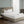 Serta white heated mattress pad on a bed with a tufted headboard