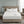Serta heated mattress pad on a bed with two white pillows and two remote controllers