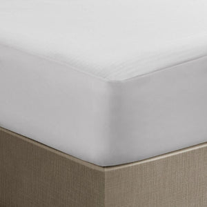 Serta white mattress protector fitted on a bed corner