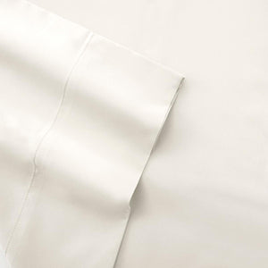 Close up of folded white cotton bed sheet with hemstitch detail