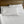 Shavel white bed sheets and pillows on a wooden bed frame