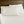 Shavel white bed sheets and pillowcases on a bed with a wooden headboard