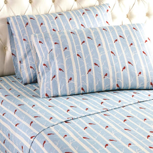 Shavel bed sheets with blue and white birch tree pattern and red cardinal birds