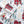 Shavel fabric featuring a winter pattern of red cabins, deer, and evergreen trees on a white background