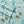 Light blue fabric with a pattern of deer cabins and snow covered pine trees