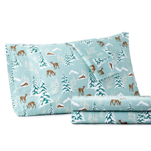 Shavel sheet set with light blue background featuring deer and snowy pine tree forest pattern