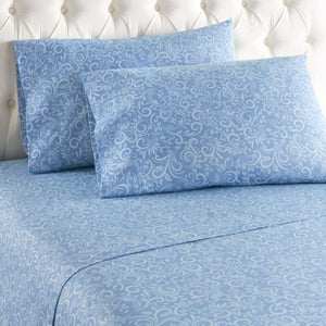 Shavel blue and white floral scroll pattern sheet set on a tufted headboard bed