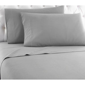 Shavel grey bed sheet set with two pillows on a tufted headboard