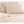 Shavel beige pillowcases and bed sheet set on a tufted headboard
