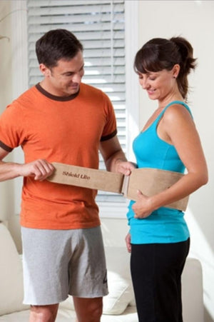 Man helping woman fasten a Shield Life back support belt