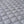 Close up of grey quilted fabric with diamond pattern