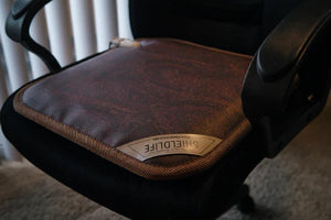 Shield Life warming seat pad on a black office chair