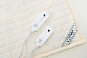 Shield Life quilted heating mat with two white digital controllers