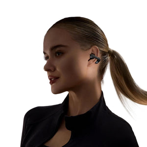 Woman wearing black Shokz open ear headphones