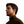 Profile view of a man wearing black open ear wireless headphones