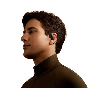 Profile view of a man wearing black open ear wireless headphones