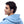 Person wearing light blue Shokz open ear headphones