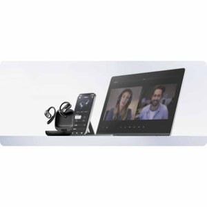 Shokz open ear earbuds in charging case next to a smartphone and laptop displaying a video call