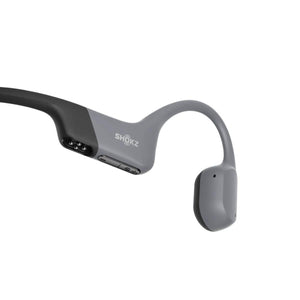 Shokz bone conduction headphones side view showing charging port and volume buttons