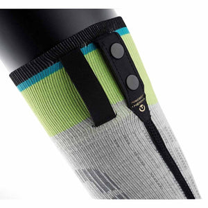 Close up of a grey and lime green compression sleeve with black snap button attachment